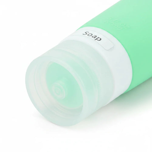 imgi_11_Close-up_of_clear_bottom_cap_with_soap_label_window_on_mint_green_silicone_travel_squeeze_bottle