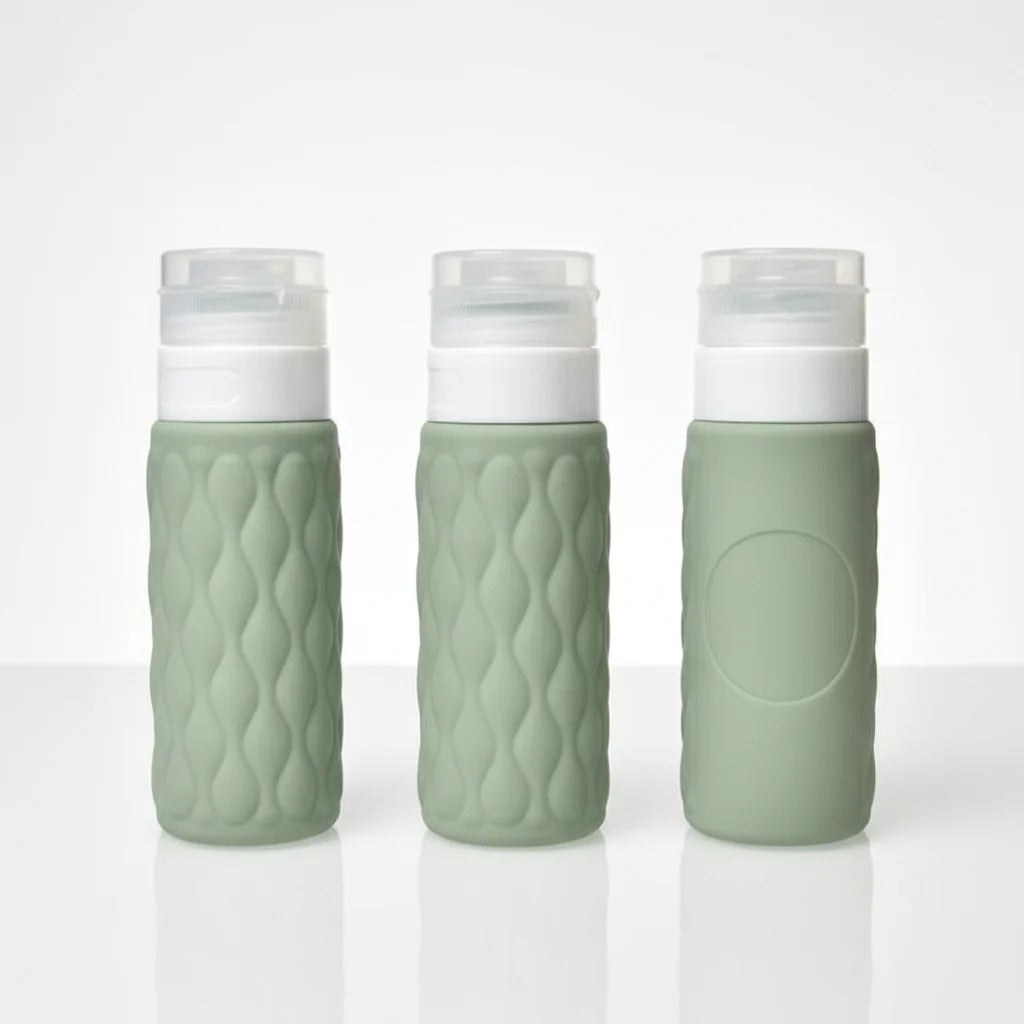 imgi_12_Three_sage_green_diamond_textured_silicone_travel_bottles_showing_front_side_and_back_angles_on_white_background